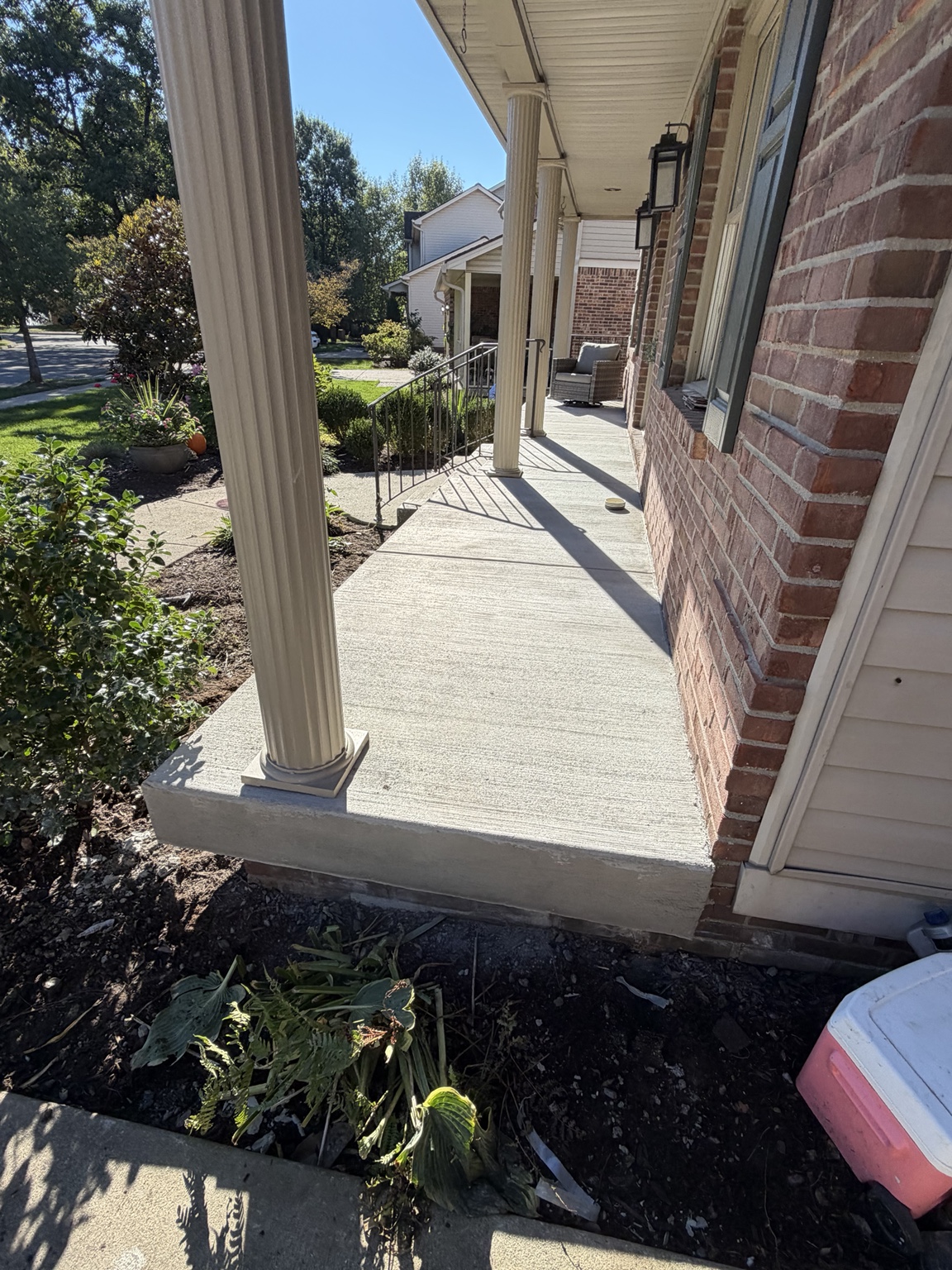 Side view showing the finished concrete porch surface and edge