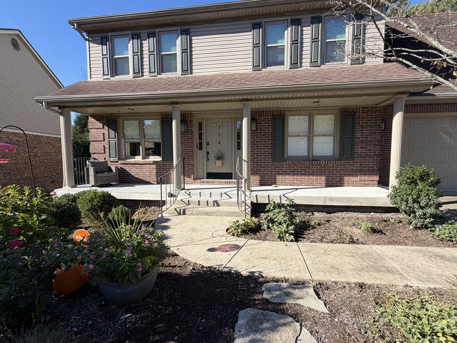 Front view of a concrete porch and steps at a brick home